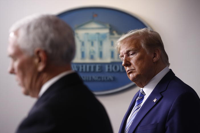 President Trump listens as Vice President Pence speaks during a coronavirus task force briefing in April. A former Pence aide said Trump prioritized his reelection over concern for people getting sick.