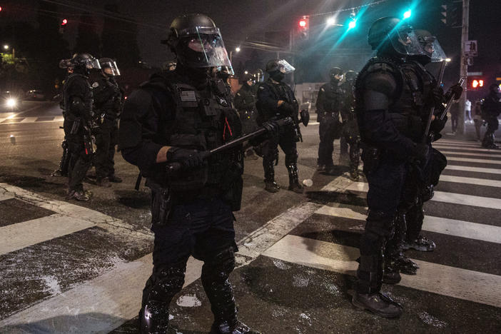 Police stand guard as protesters take to the streets on Sept. 4 in Portland, Ore.