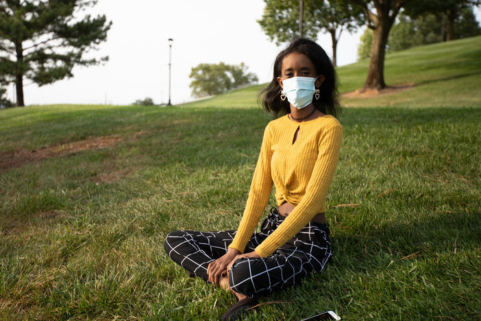 Huda Mohamed, a student at James Madison University in Harrisonburg, Va., has an immunodeficiency. She decided to take extra precautions by using Virginia's COVIDWISE app, which alerts users who may have been exposed to the coronavirus. Such apps are only available in a few states.