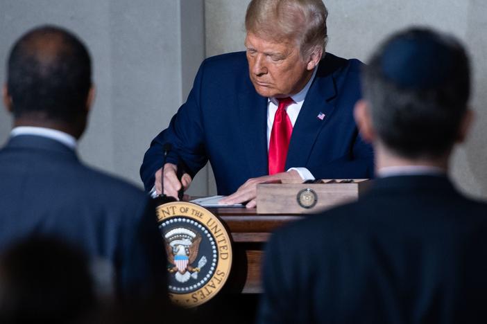 President Trump holds a Constitution Day proclamation after speaking Thursday during the White House Conference on American History at the National Archives in Washington, D.C.