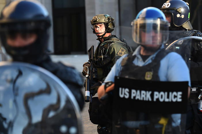 U.S. Park Police and other federal officers hold a perimeter near the White House on June 1 as demonstrators gather to protest the killing of George Floyd.