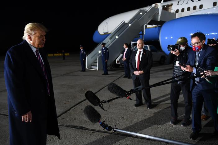 President Trump reacts to the news of Justice Ruth Bader Ginsburg's death on Friday at Bemidji Regional Airport in Minnesota. He told reporters on the tarmac after his rally that he learned the news from them.