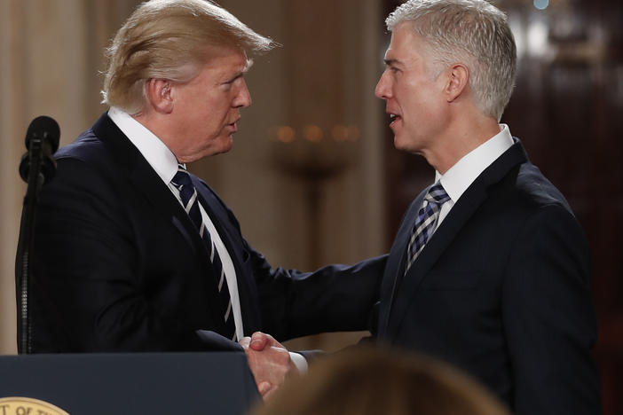 President Trump shakes hands with Neil Gorsuch, his first pick for a spot on the U.S. Supreme Court, on Jan. 31, 2017. The president will likely have the opportunity to name a replacement for Justice Ruth Bader Ginsburg, who died Friday.