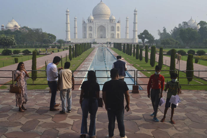 Tourists visit the Taj Mahal on Monday, when it reopened after being closed for more than six months due to the coronavirus pandemic.