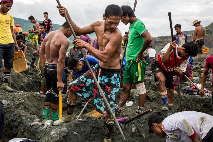 Freelance miners dig for raw jade at a company site in Hpakant, Myanmar, in 2018.