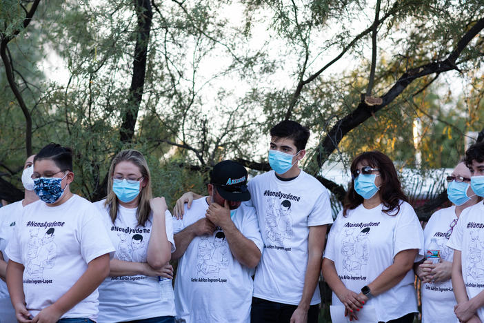 Community members and family wear shirts that read "Nana Ayudame or Nana, help me" in Spanish at a vigil for Carlos Ingram-Lopez on June 25 in Tucson, Ariz. Prosecutors have declined to pursue criminal charges over his death in police custody.