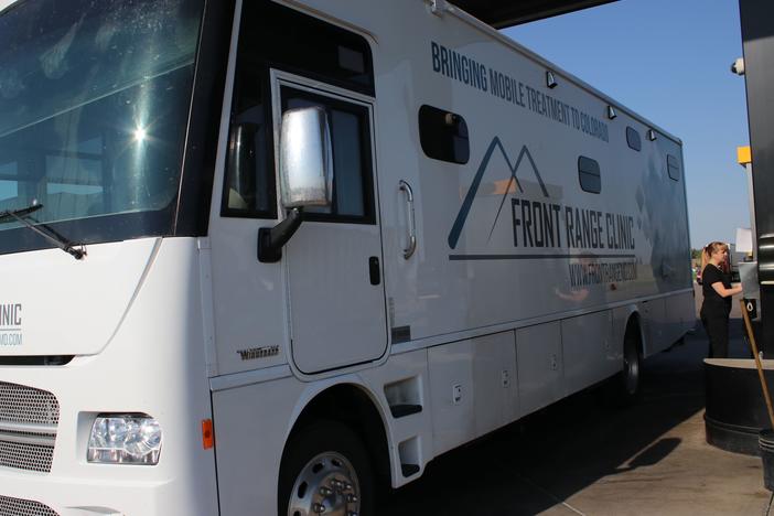 Each mobile clinic has a nurse, a counselor and a peer specialist — all trained to drive a 34-foot-long motor home. "I never thought when I went to nursing school that I'd be doing this," says Christi Couron as she pumps 52 gallons of diesel fuel into the vehicle.
