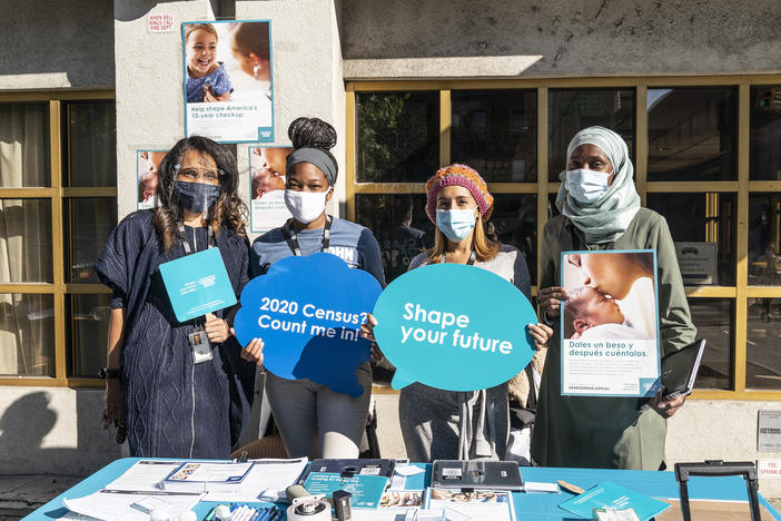 U.S. Census Bureau workers promote the national head count outside of Sylvia's Restaurant in New York City's Harlem neighborhood.