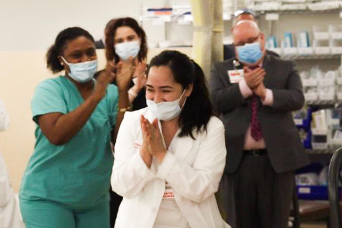 Nurses clap after Kym Villamer and her colleague Dawn Jones sing "Ain't No Mountain High Enough" at <a data-cid="12680058537081005198" data-ved="0ahUKEwjSr4K__f_rAhVmUt8KHZI2AFsQyTMIIzAA">New York-Presbyterian Queens Hospital's </a>new COVID-19 ward.