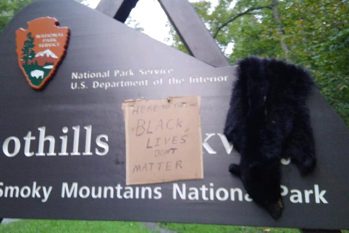 An entrance to Great Smoky Mountains National Park in Tennessee was vandalized last weekend with the skin of a black bear and a sign that read "Here To The Lake Black Lives Don't Matter."