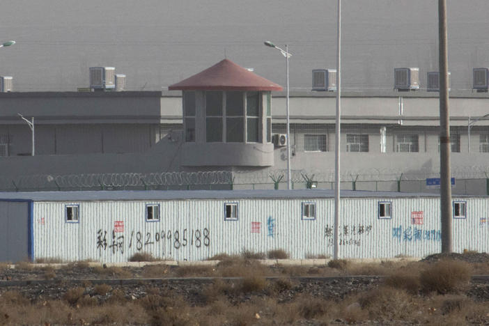 A guard tower and barbed wire fences are seen around the Kunshan Industrial Park in Artux in western China's Xinjiang region in December 2018.