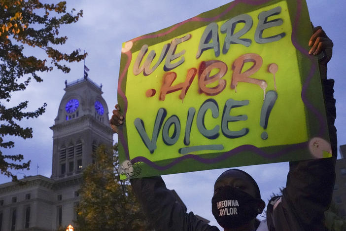 A protester stands in Jefferson Square on Thursday in Louisville, Ky., where hundreds have been holding demonstrations in the aftermath of the grand jury's decision not to charge officers for her death.