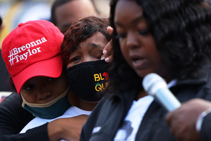 "You didn't just rob me and my family, you robbed the world of a queen," Breonna Taylor's mother, Tamika Palmer, said in a statement read aloud Friday by Palmer's sister, Bianca Austin. In this photo, Ju'Niyah Palmer is seen wiping away tears from her mother's face.