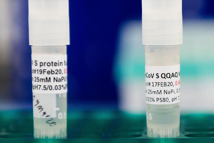 Three potential coronavirus vaccines are kept in a tray at Novavax labs in Gaithersburg, Md., in March 2020. The company has moved into phase 3 trials in the U.K.