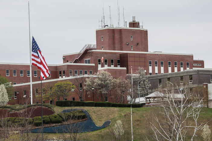 An American flag flew at half-mast at the Holyoke Soldiers' Home in Massachusetts last spring, when dozens of veterans died at the facility. Two of its leaders are now facing criminal neglect charges over their handling of a COVID-19 outbreak.