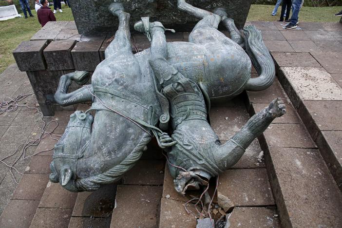 The statue of Sebastián de Belalcázar, a 16th century Spanish conquistador, lies on the ground after it was pulled down by Indigenous people in Popayán, Colombia, earlier this year.