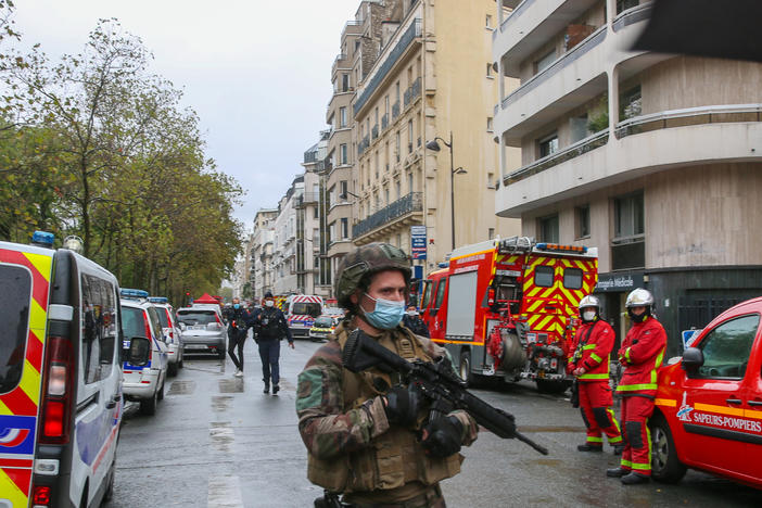 An officer of the French National Gendarmerie guards an area near the former Paris offices of satirical newspaper <em>Charlie Hebdo,</em> where two people were wounded Friday in an attack with a sharp object that one witness described as a hatchet.