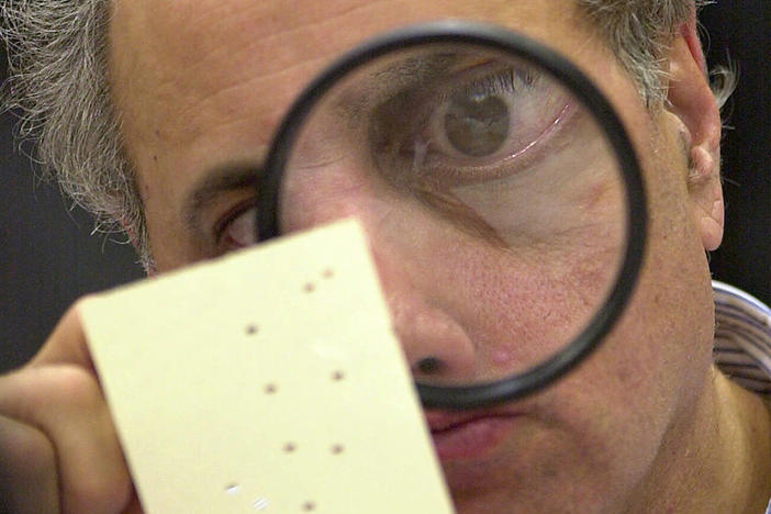 Judge Robert Rosenberg, a member of the Broward County, Fla., canvassing board examines a disputed ballot in Fort Lauderdale, Fla., on Nov. 24, 2000. That close presidential contest was one of several in U.S. history.
