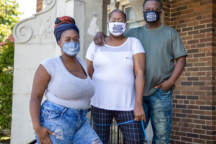 Heavenly Pettigrew, left, and her parents Stephanie and Robert outside their two-bedroom rental apartment in Milwaukee. Without assistance from the nonprofit Community Advocates, the family likely would have faced eviction after the pandemic forced Robert and Heavenly out of their steady jobs.