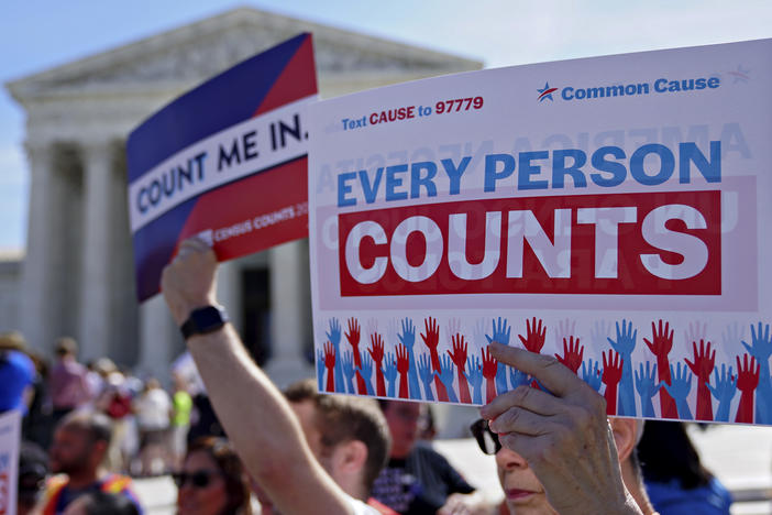 Demonstrators hold signs about the 2020 census outside the U.S. Supreme Court in 2019.