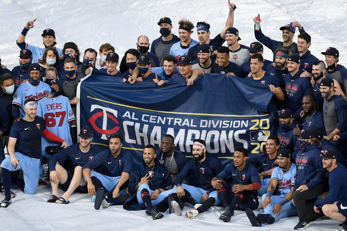 The Minnesota Twins celebrate being the American League Central Division champions after the game against the Cincinnati Reds on Sunday in Minneapolis.