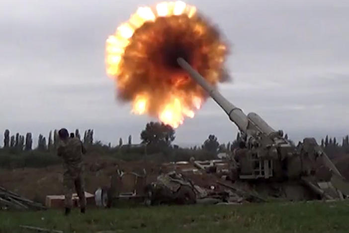 A howitzer fires munitions toward Armenian positions Monday. Violence between Armenia and Azerbaijan erupted Sunday in the disputed region of Nagorno-Karabakh.