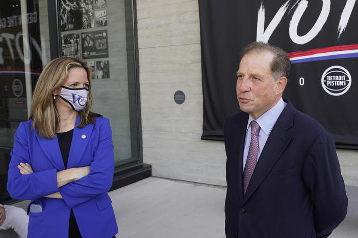 Michigan Secretary of State Jocelyn Benson (left) and Detroit Pistons Vice Chairman Arn Tellem talk about voting last Thursday, when balloting began in the state. The Pistons are allowing their arena to be used as a polling station.
