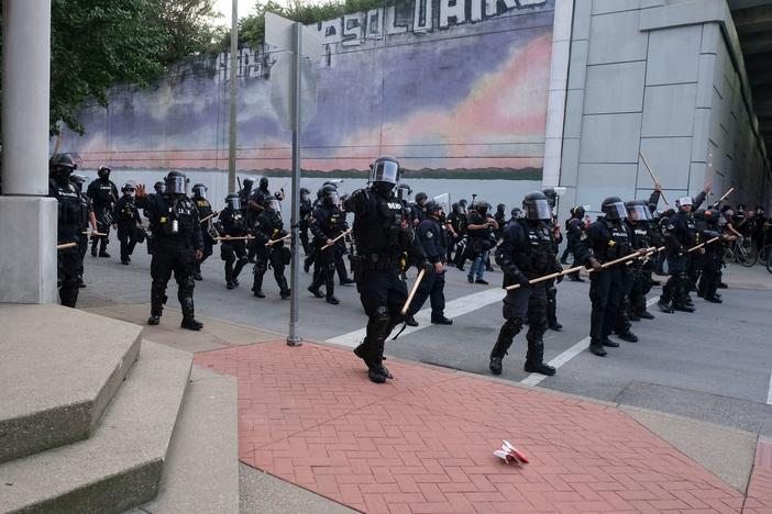 A police line approaches demonstrators in downtown Louisville, Ky., last week during protests over the lack of criminal charges in the police killing of Breonna Taylor and the result of a grand jury inquiry.