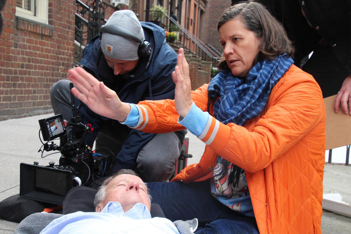 Filmmaker Kirsten Johnson stages one of her father's "deaths" in<em> Dick Johnson Is Dead. </em>