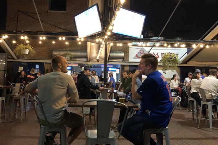 Sox fan Steve Nitz (left) and Cubs fan Paul Schmitz watch the crosstown rivals play each other last weekend in the beer garden at Bernie's Tap and Grill across the street from Wrigley Field in Chicago.