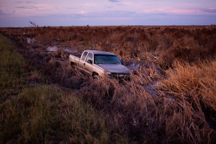 A truck sits in still water after Hurricane Laura swept through Cameron Parish, La. The hurricane inflicted at least $8 billion in damage to southwest Louisiana when it hit in late August.