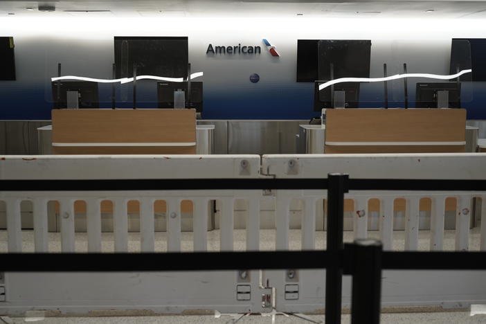 American Airlines check-in counters sit closed last month behind plastic barriers at Los Angeles International Airport.