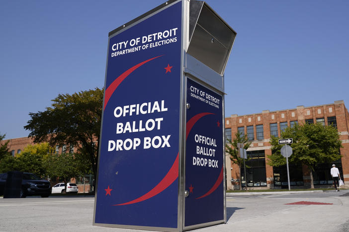 Voters can drop off absentee ballots at a ballot drop box in Detroit instead of using the mail.