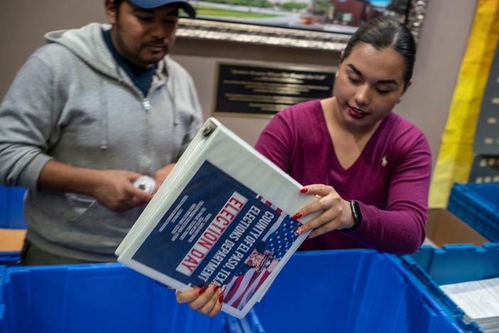 Jonathan Lucero and Valeria Gutierrez prepare to receive ballots at the El Paso County Courthouse during the presidential primary in March.