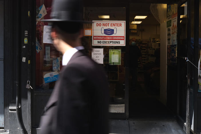 Residents walk through the Brooklyn neighborhood of Borough Park on September 23 in New York City. Borough Park is one of numerous Brooklyn neighborhoods that are witnessing a spike in the number of COVID-19 cases.