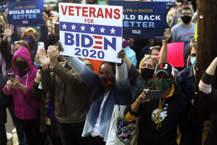Supporters gather outside a train station Wednesday to greet former Vice President Joe Biden in Latrobe, Pa. The Biden campaign announced it will begin in-person canvassing as the election nears.