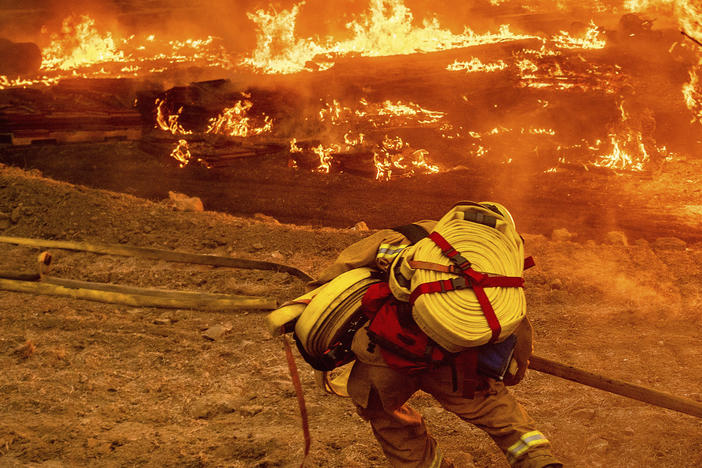 A firefighter battles the Glass Fire in Napa Valley, Calif., on Thursday.