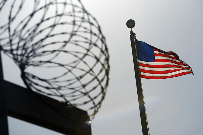 A U.S. flag flies above a fence at the detention facility at the U.S. Naval Station at Guantánamo Bay, Cuba, on Dec. 10, 2008, in an image reviewed by the U.S. military.
