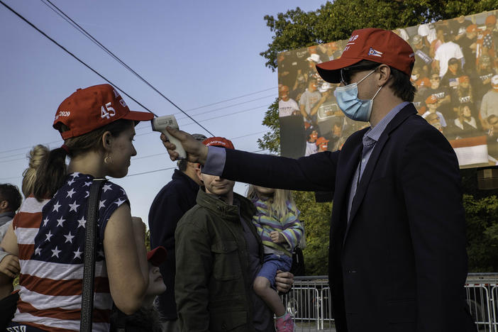 A temperature check is conducted at a Trump campaign rally last month in Toledo, Ohio.