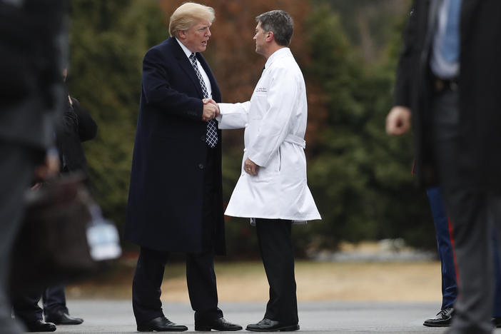 President Trump shakes hands with now-former White House physician Dr. Ronny Jackson in January 2018 following his first medical checkup as president.