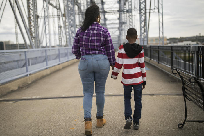 Freda and her 9-year-old son visit the Purple People Bridge in Cincinnati. She and her five children have been living in the front room of a friend's apartment, sleeping on pads of bunched-up comforters.
