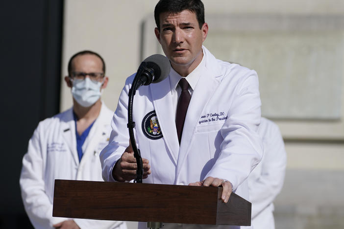 Dr. Sean Conley, physician to President Trump, talks with reporters at Walter Reed National Military Medical Center on Monday.