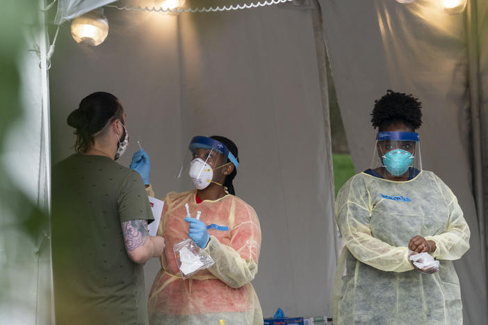 A nurse with the Washington, D.C. Dept. of Health is shown administering a coronavirus test last month. D.C. is now seeing a spike in demand for testing.