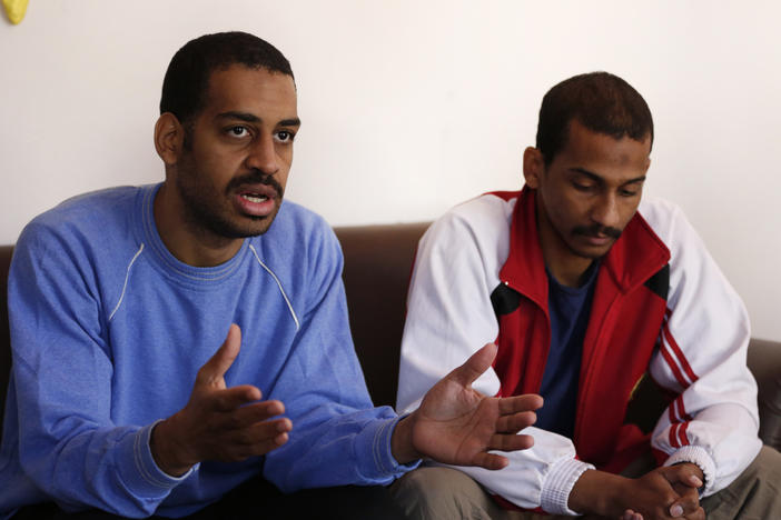 Alexanda Kotey (left) and El Shafee Elsheikh, who were allegedly among four British jihadis who made up a brutal Islamic State cell dubbed "The Beatles," speak during an interview with The Associated Press at a security center in Kobani, Syria, in March 2018.