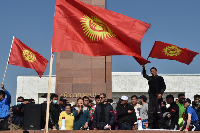 People protest beside the parliament building in Bishkek, which also houses the offices of Kyrgyzstan's president, during protests on Monday.