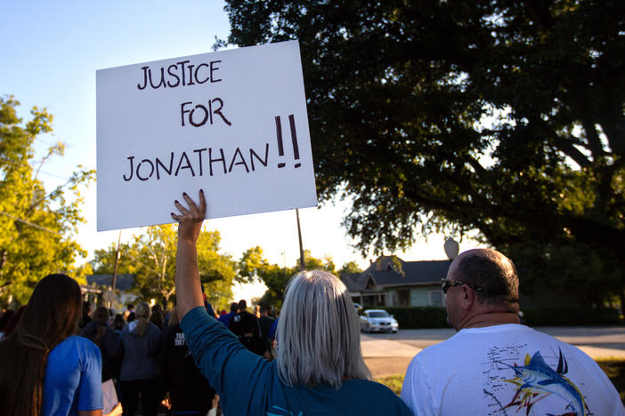 People gather for a march, rally and candlelight vigil in honor Jonathan Price in Wolfe City, Texas, on Monday. Wolfe City police officer Shaun Lucas has been charged in relation to the fatal shooting.