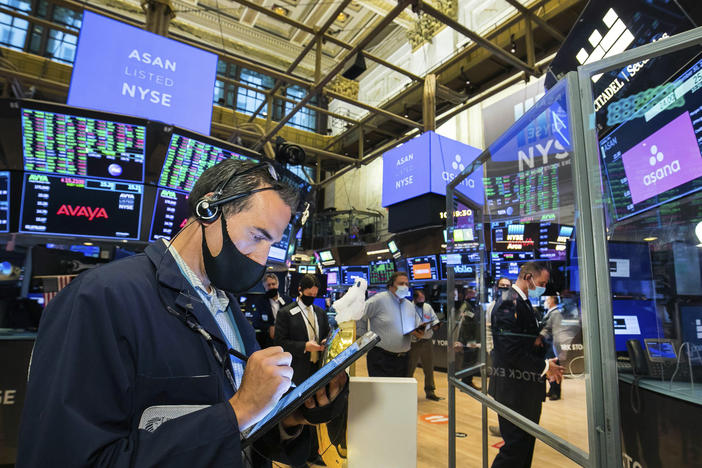 Traders gather on the New York Stock Exchange trading floor on Sept. 30. Major U.S. stock indexes rose Wednesday after President Trump said he'd be willing to consider economic relief measures. Trump earlier had called off such talks with lawmakers.