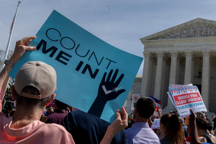 Protesters holding signs about the 2020 census gather outside the Supreme Court in Washington, D.C., in 2019.
