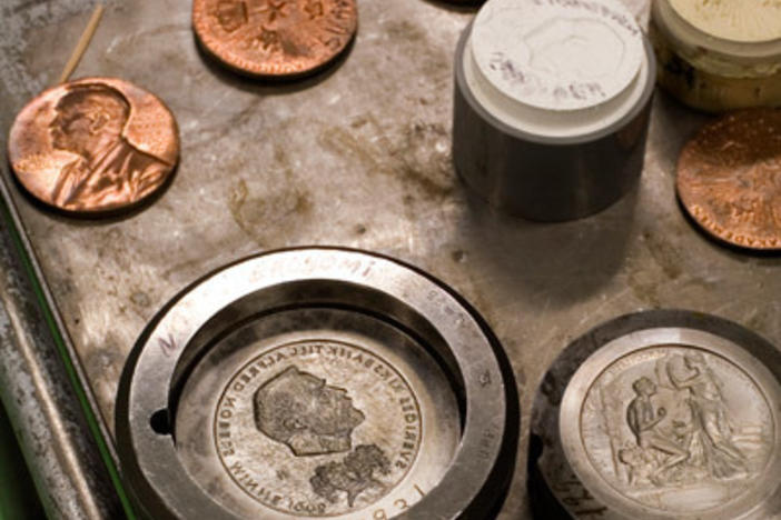 Nobel Prize gold medals during manufacture at the Swedish Mint. The front of the medal has the likeness of Alfred Nobel.