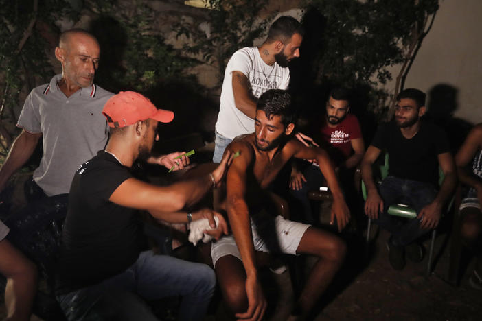 Ibrahim Lasheen, 22, is brought back to his hometown of Tripoli, Lebanon, in September. A U.N. naval force rescued him after he swam for 18 hours to seek help for dozens of fellow passengers crammed on a small fishing boat that ran out of fuel as it headed to Cyprus.